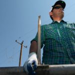Image of a worker moving an irrigation pipe safely