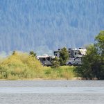 A boat across a river near a campground