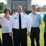 Men and women standing in front of the Salvation Army