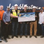 Image of Idaho Power employees presenting an incentive check to Lamb Weston for energy efficiency.