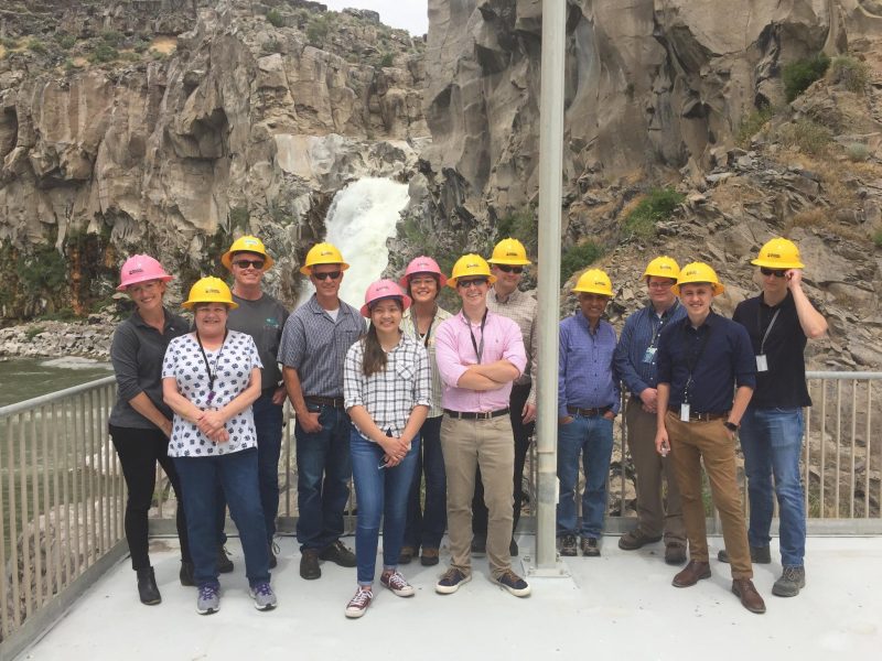 Image of a group of engineering interns at a hydro power facility.