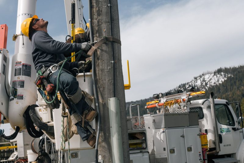 Image of a lineman apprentice climbing a power pole.