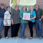 Group of Idaho Power employees and senior center folks receiving AED donation.