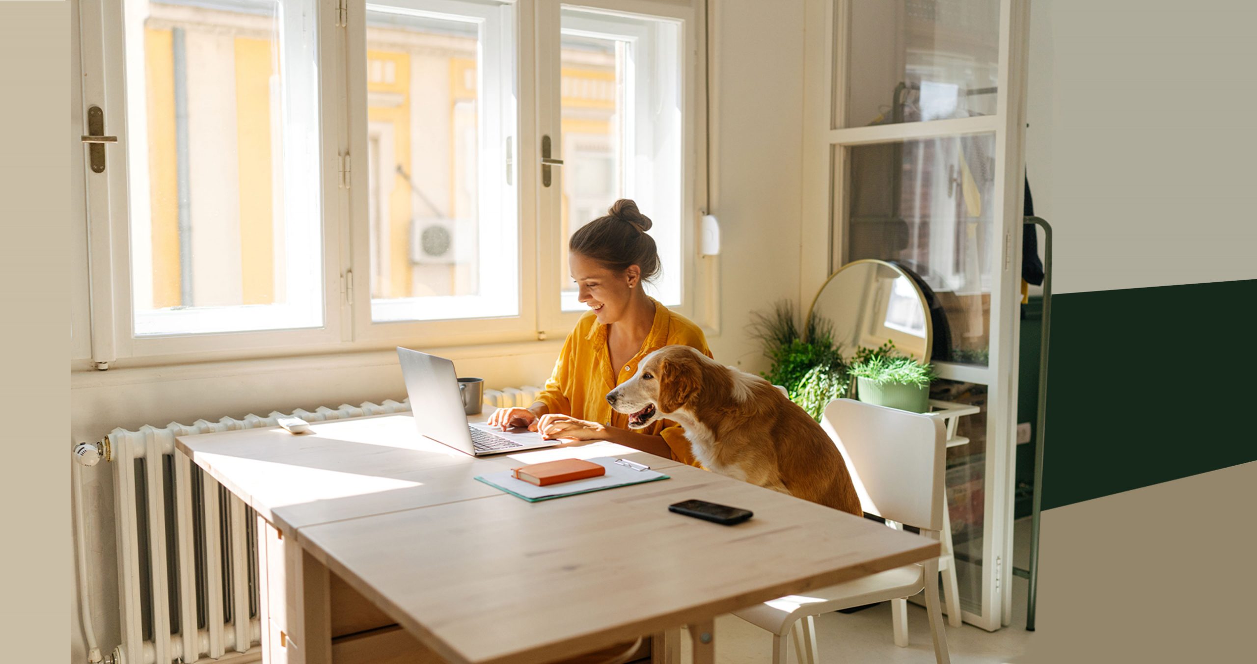 Women with dog and laptop at computer, smiling
