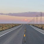 Open road with transmission lines along the side