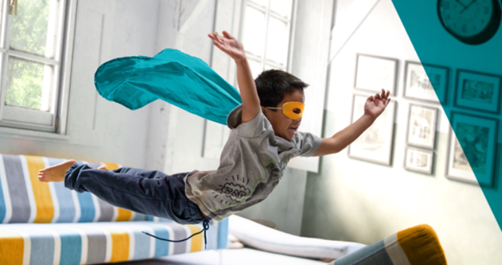 Boy jumping off a couch in a living room