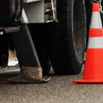 Traffic cones by a work truck on the road