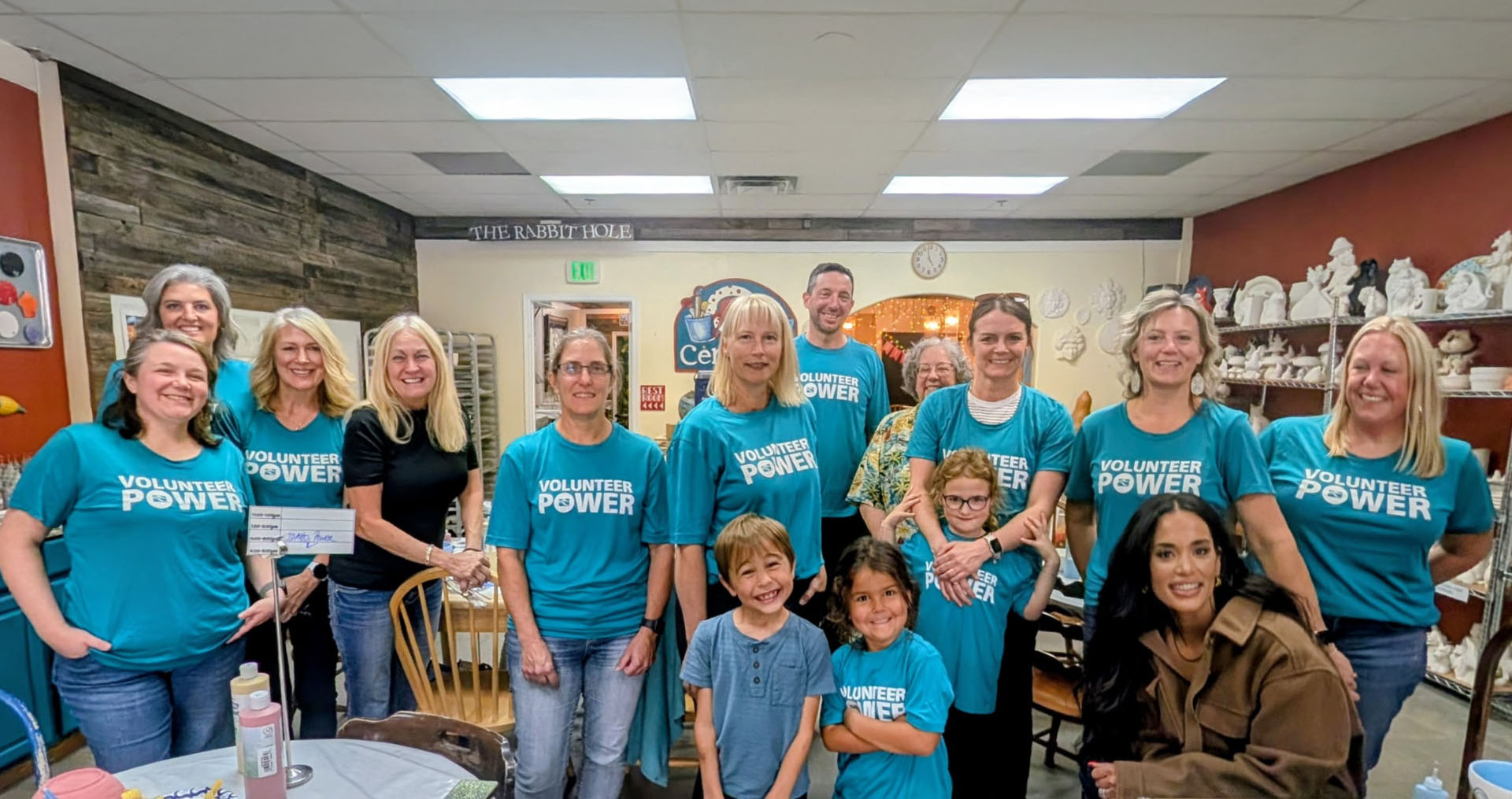 Idaho Power employees and kids volunteering by painting pottery