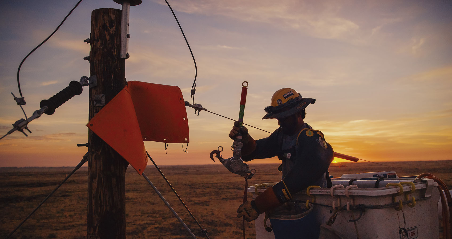 Idaho Power lineman working on equipment in a bucket truck