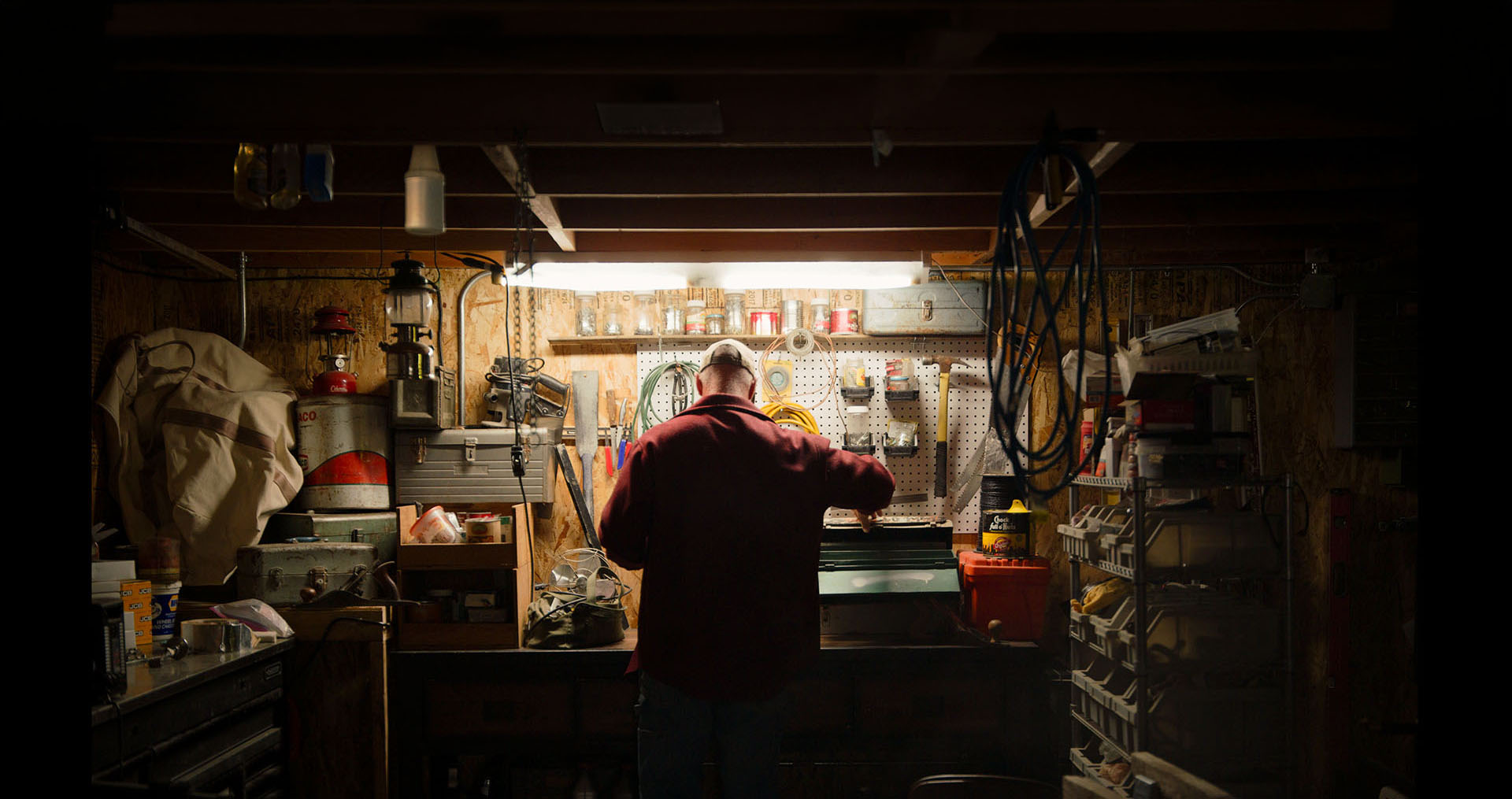 Idaho Power customer working at a tool bench with the light on